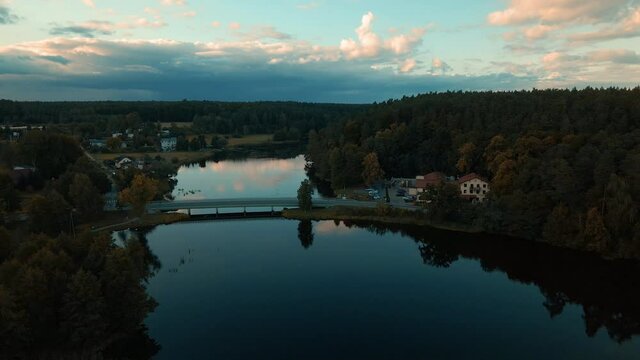 The Beautiful and Peaceful View Of Tlen in Poland With Long Bridge and Calm River During Nighttime - Aerial Shot