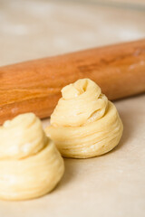 raw cruffins before baking in the oven. puff pastry like a muffin rolled into a roll. modern baking. close-up, space for text. vertical photo