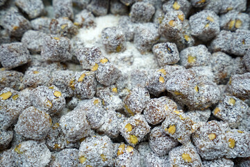 Close up display shelf of Turkish delight (lokum)- confections based on a gel of starch and sugar, Premium varieties consist largely of chopped dates, pistachios, and hazelnuts