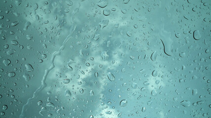 Rain droplets falling on the glass, a rainy day in autumn