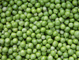 FRESH green peeled peas texture top view