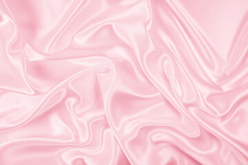 Beautiful elegant wavy light pink satin silk luxury cloth fabric texture, abstract background design. Copy space
