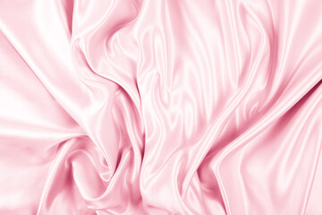 Beautiful elegant wavy light pink satin silk luxury cloth fabric texture, abstract background design. Copy space
