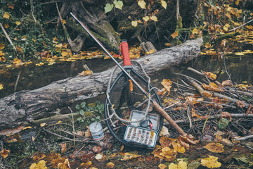 Fly rod and fly box on the bank of the stream.