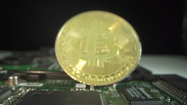 Gold bitcoin rotate on the micro chip. Blockchain technology of digital modern money. Macro shot. Cryptocurrency. Dark background