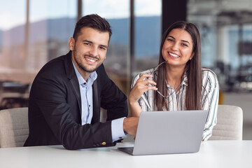 Coworkers team at work. Group of young business people in trendy casual wear working together in creative office.