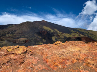 Stunning view of volcano mountain Etna landscape with colorful red-orange volcanic stones on Sicily, Italy