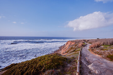 Picturesque pathway on rock ocean shore, Portugal.