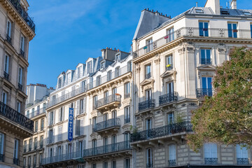 Paris, typical facades and street, beautiful buildings at Republique, with an hotel sign