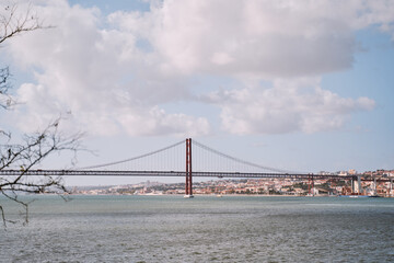 Beautiful landscape with suspension 25 April bridge bridge over the Tagus river in Lisbon, Portugal.