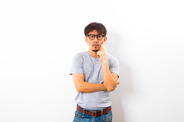 Fototapeta premium Asian adult with glasses on grey T-shirt thinking and looking outside on white background.