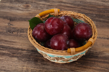 Plum heap in the wooden basket