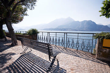 Beautifil landscape with bench on the promenade of Como Lake, Italy.