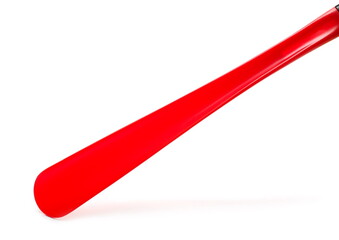 Red plastic shoehorn, shoe spoon isolated on white background