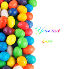 Multicolored candies isolated with space for text