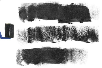 Sponge roller with abstract black paint, dye shapes and lines isolated on white background, top view