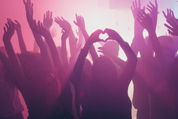 Photo of big company concert many funky people girl show fingers heart figure neon bright spotlight...