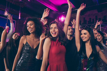 Photo portrait of excited young people dancing together at nightclub ladies wearing beautiful red shiny fancy elegant dresses