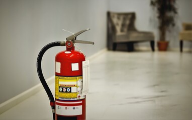 Red tank of fire extinguisher.