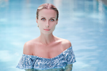 Enjoying vacation. Sensual portrait of  beautiful young woman in swimming pool.