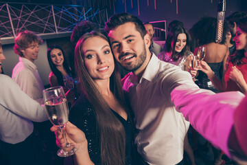 Self photo portrait of cute couple at luxury party holding champagne glass