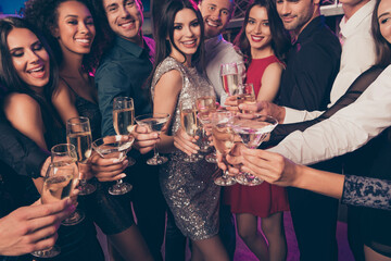 Cropped photo portrait of people clinking champagne glasses at party © deagreez