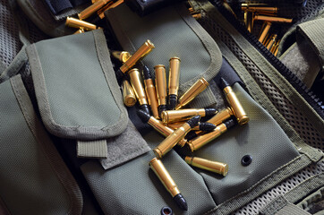 Ammunition 7,62*39.Tactical unloading vest as background. 