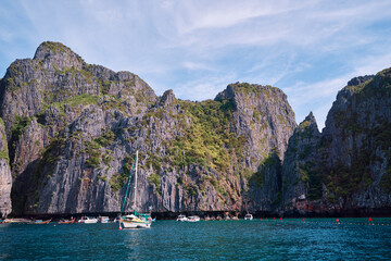Travel by Thailand. Beautiful tropical lanscape with yacht sailing the sea with famous Maya Bay on...