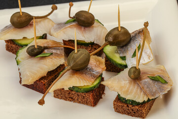 Herring fillet canape with caperberry