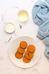 Carrots falafel balls with greek yogurt deep. White background