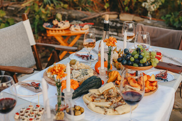 A little boy on a dark background looks gently at his pet rabbit and strokes his hand.