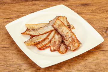 Roasted juicy bacon in the plate