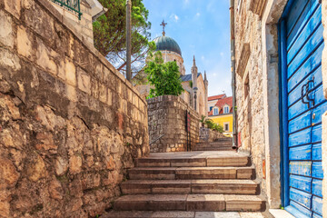 Fototapeta na wymiar Narrow european street near Church of St. Jerome in Herceg Novi, Montenegro