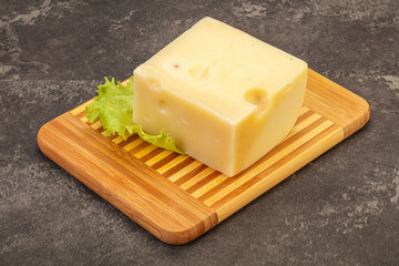 Emmental cheese over wooden board