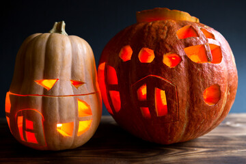 Spooky Jack-shaped pumpkin for Halloween with cut-out eyes, Windows and door and a flickering...