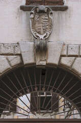 the ancient shield with the snake symbol of Milan carved on the entrance of an ancient building.Lombardy,Italy