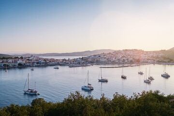 Travel by Greece. Beautiful view of Ermioni sea lagoon with moored yachts at sunset time.