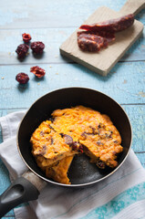 Italian frittata with peppers and red sausage