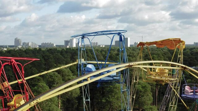 Flight Over The Ferris Wheel. Ferris wheel at park. Close-up shot of colorful ferris wheel. Old Soviet Ferris Wheel abandoned during pandemic. City quarantine aerial