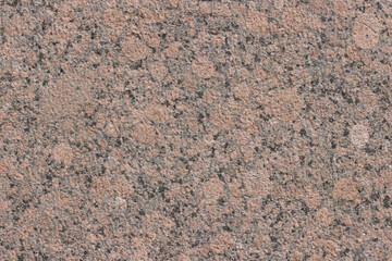 The texture of a variegated speckled polished marble slab.