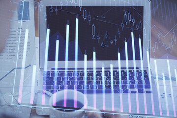 Forex Chart hologram on table with computer background. Double exposure. Concept of financial markets.