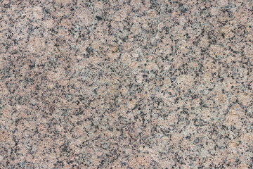 The texture of a variegated speckled polished marble slab.