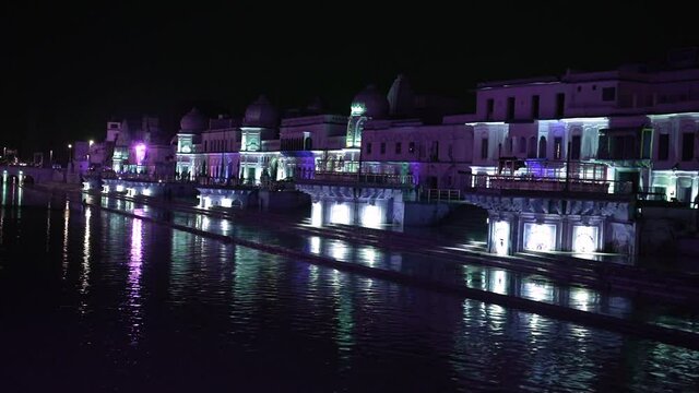 Scenic View Of Ram Temple Illuminated By Colorful Lights During Evening By The Lake Sarayu In Ayodhya City, Agra India. - Wide Shot