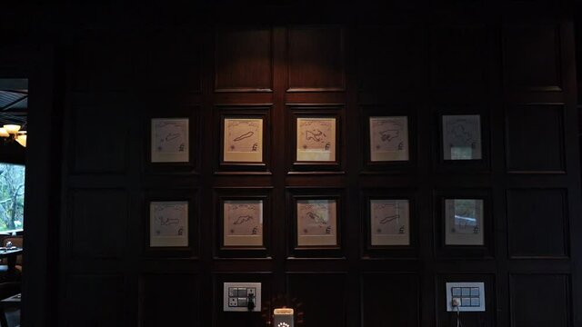 Revealing Shot Of Artistic Frames Hanging On The Wooden Wall Of A Hotel