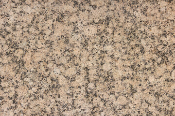 The texture of a variegated speckled polished marble slab.