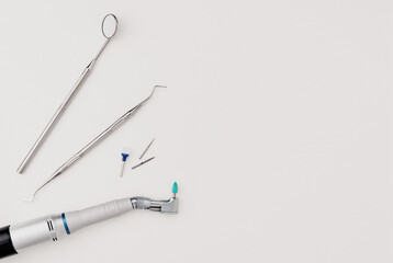 Basic dentist tools on white table.