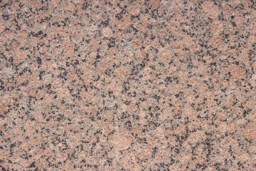 The texture of a variegated speckled polished marble slab.
