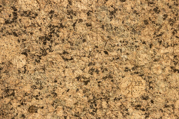 The texture of a variegated speckled polished marble slab.