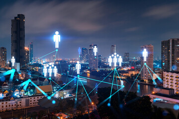 Glowing Social media icons on night panoramic city view of Bangkok, Asia. The concept of networking and establishing new connections between people and businesses. Double exposure.