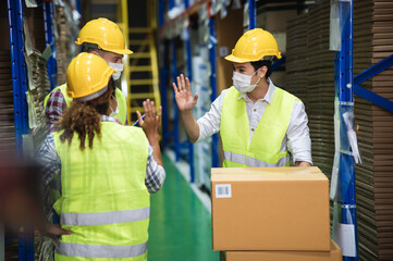 Diverse males warehouse colleague  wear face mask, keeping social distancing and greeting by...